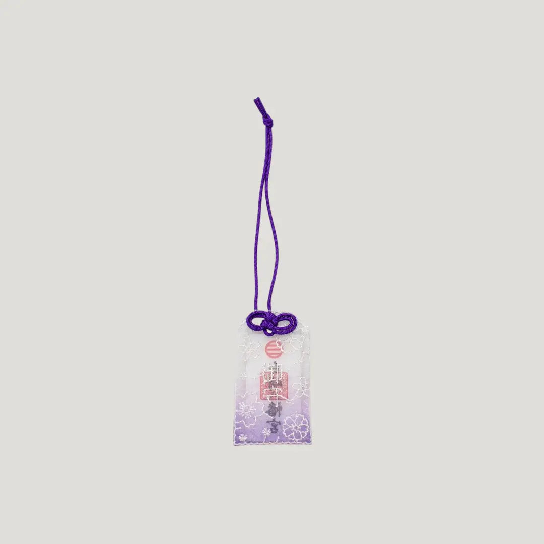 Embroidered Sakura Omamori with purple cord and lace cherry blossom design from Shirasaki Shrine