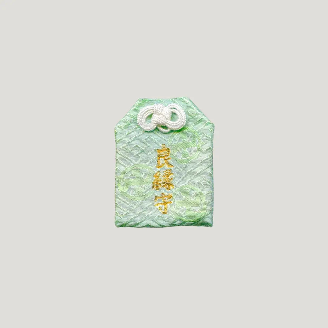 Good Match Omamori from Sensoji Temple in green with floral embroidery, symbolizing peaceful relationships and balance