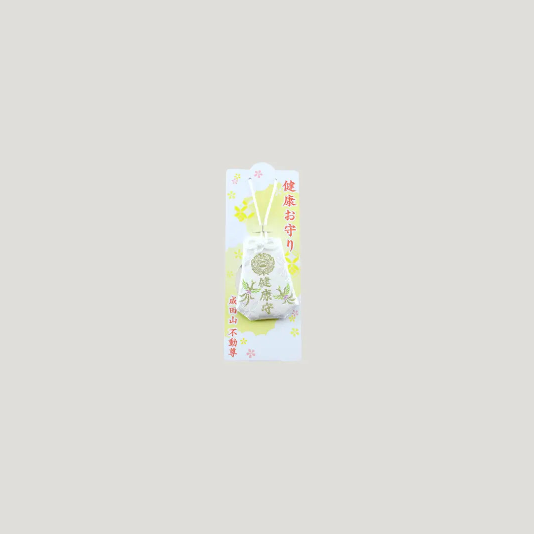 Health Omamori from Osaka Naritasan Fudoson with soft white fabric, gold crest, and green bamboo embroidery for wellness and protection