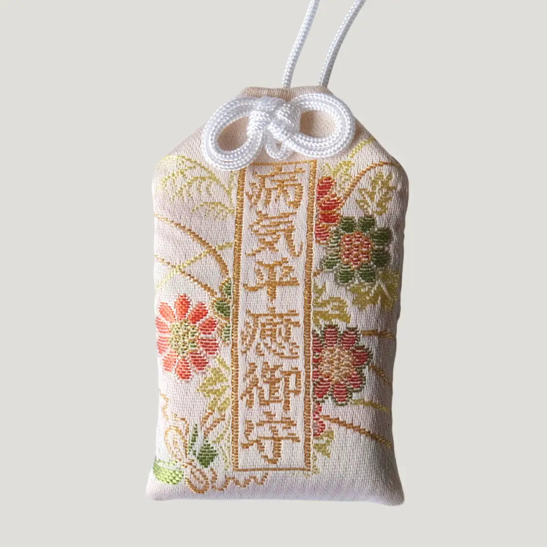 Recovery Omamori from Koenji Hikawa Shrine with floral embroidery on cream fabric, symbolizing healing, peace, and strength during illness
