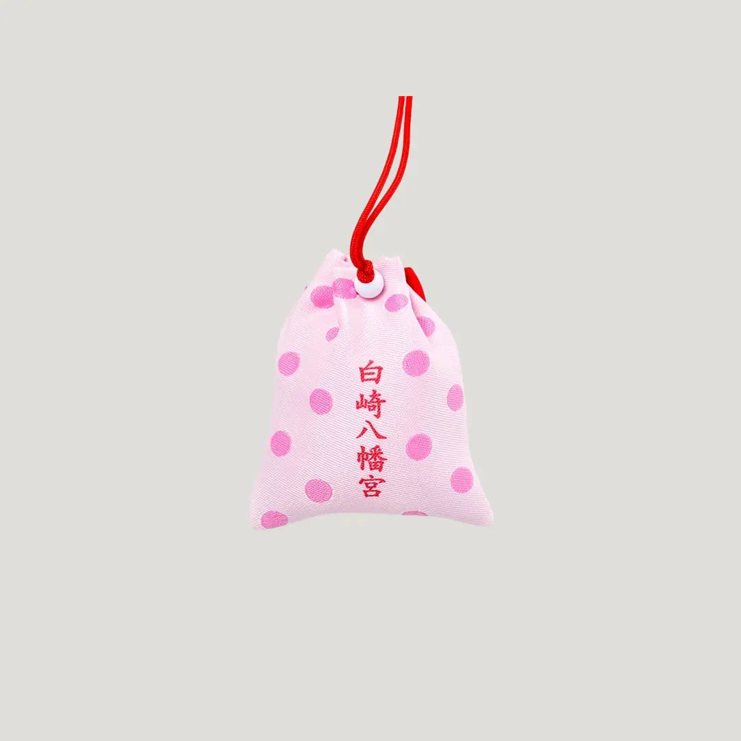 Safe Childbirth Omamori (安産お守り) back side – pink charm with red shrine name and polka dot pattern from Shirasaki Shrine