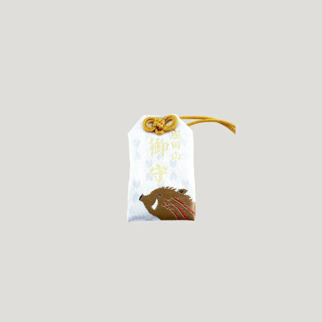 Boar Zodiac Omamori from Osaka Naritasan Fudoson featuring a running wild boar with golden cord