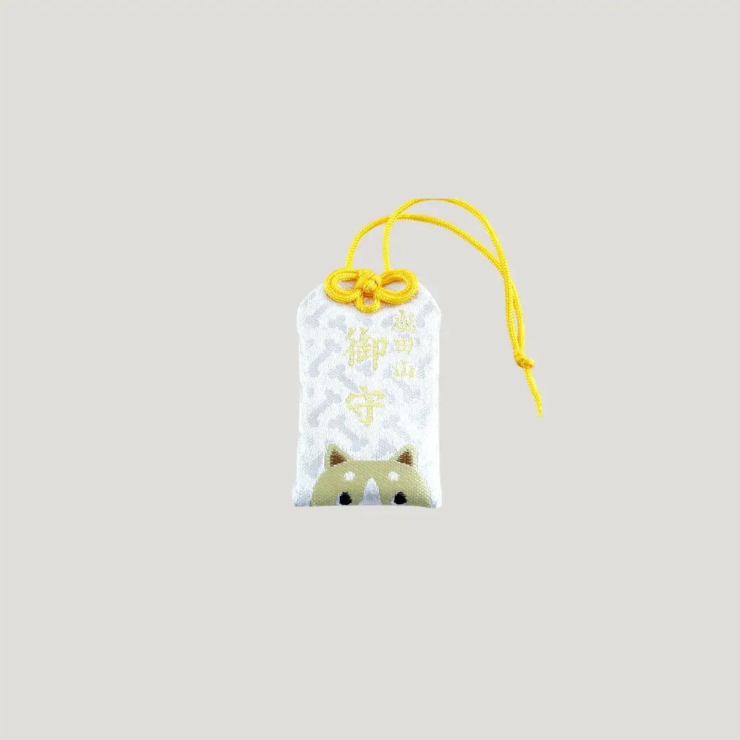 Dog Zodiac Omamori from Osaka Naritasan Fudoson featuring a shiba-like face with yellow cord