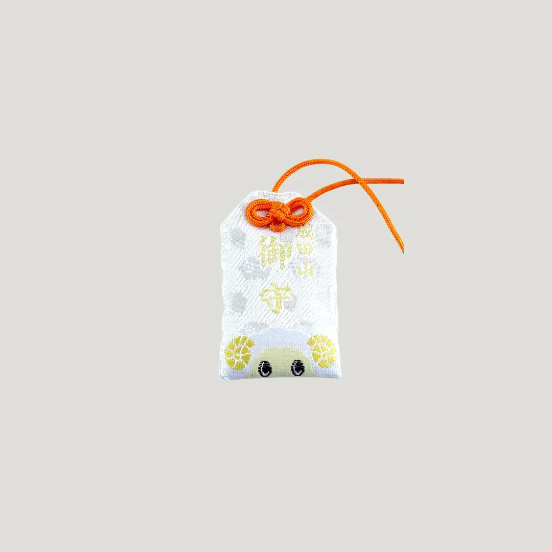 Sheep Zodiac Omamori from Osaka Naritasan Fudoson with cute yellow-horned sheep and orange cord