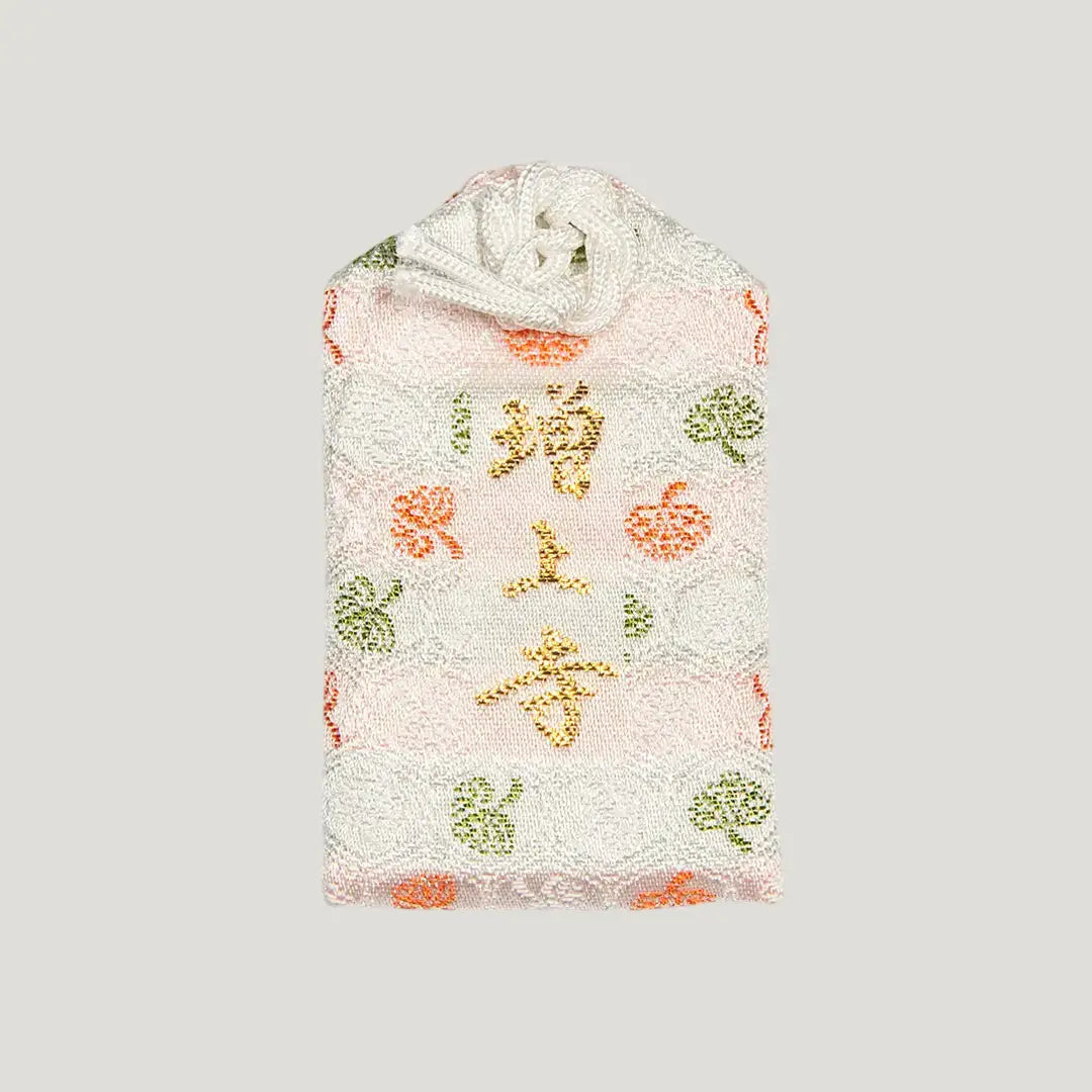 Back of 学業御守 (Academic Success Omamori) from Zojoji Temple – light pink charm with 増上寺 embroidered in gold