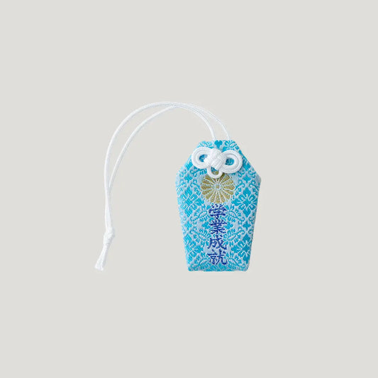 Academic Success Omamori in blue with chrysanthemum design from Meiji Jingu Shrine Tokyo
