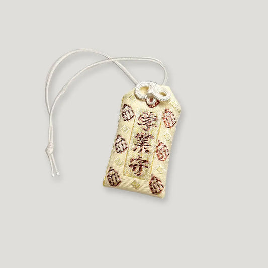 Front of academic success omamori (学業守) from Izusan Shrine, Shizuoka – ivory variant with traditional embroidery for study and exam success