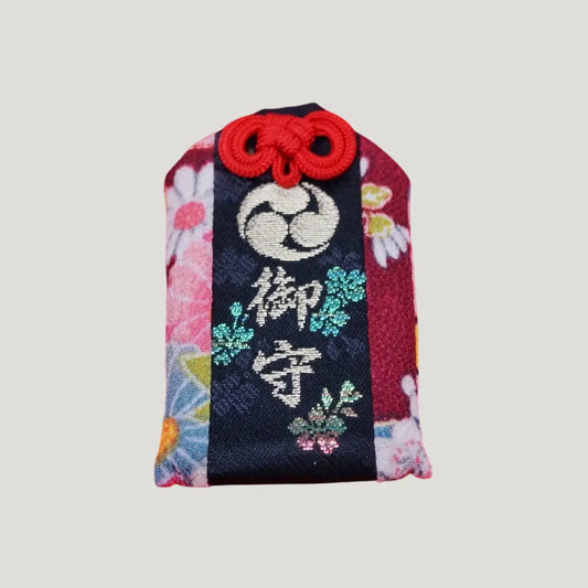 A traditional Japanese omamori for body protection from Dewa Sanzan Shrine, shown on its original card.