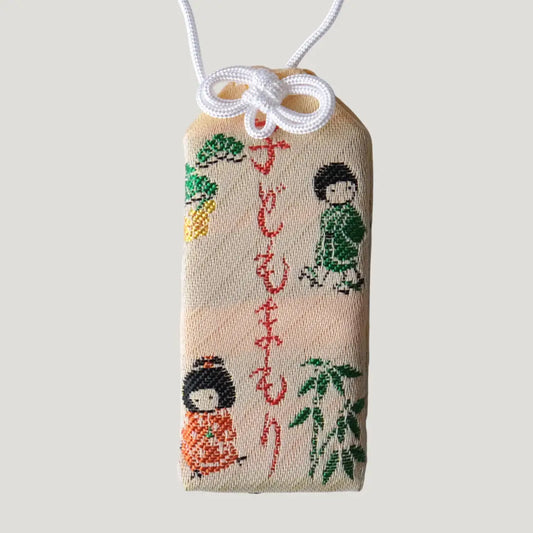Child Safety Omamori from Koenji Hikawa Shrine with embroidered children and nature motifs on cream fabric, symbolizing protection and well-being