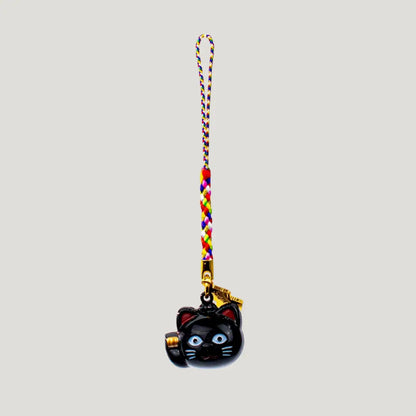 Fortune Beckoning Cat Omamori – back view of black maneki-neko bell charm with gold tag and multicolor strap from Shirasaki Shrine