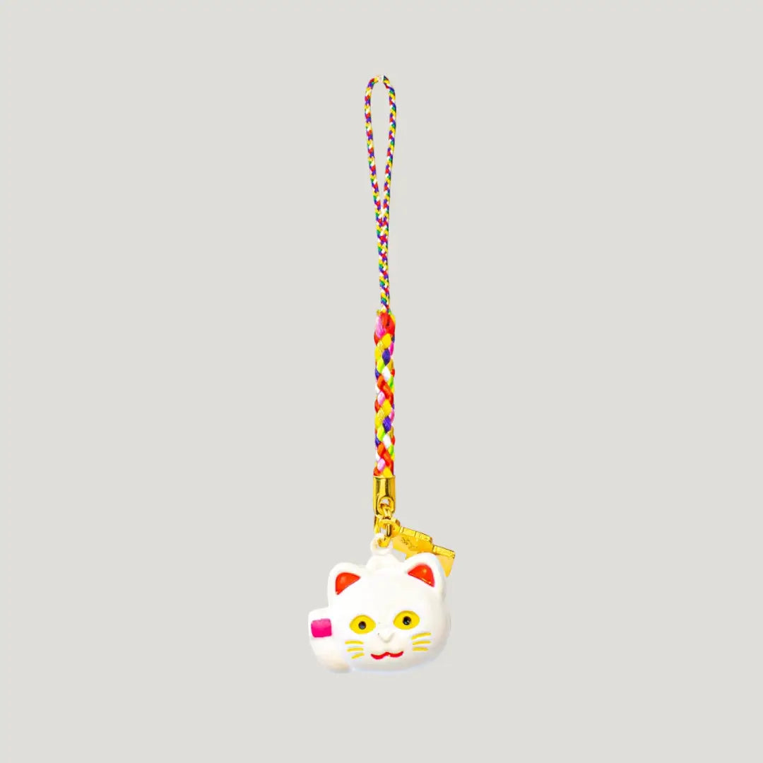 Fortune Beckoning Cat Omamori – back view of white maneki-neko bell charm with gold tag and multicolor strap from Shirasaki Shrine