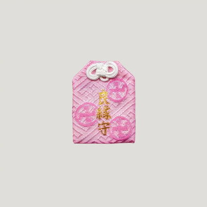 Good Match Omamori from Sensoji Temple in pink with sakura design, symbolizing romantic warmth and emotional bonds