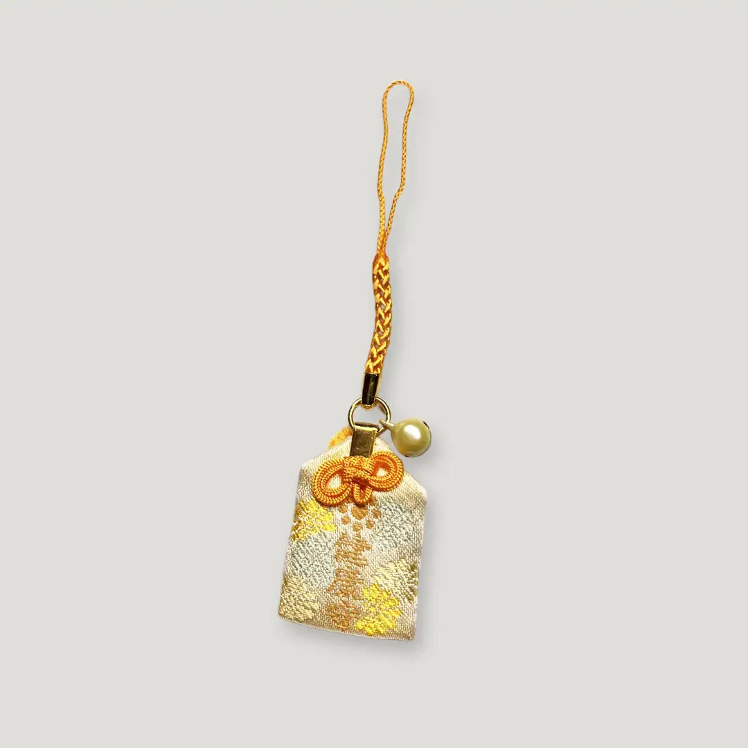 Health Omamori (健康守) from Izusan Shrine – ivory and gold charm with braided strap and pearl accent