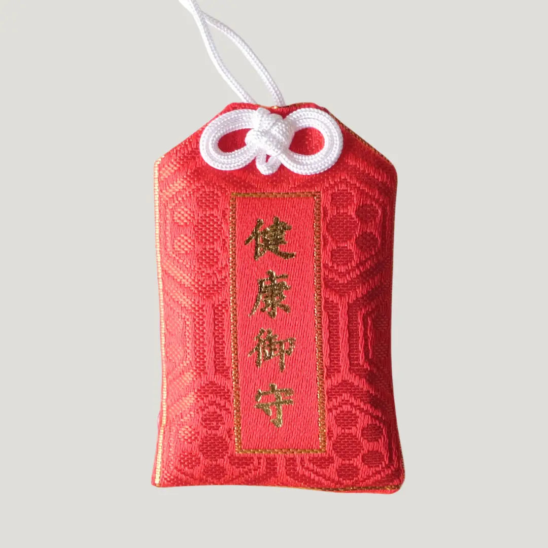Health Omamori from Koenji Hikawa Shrine in red with gold script and floral patterns, symbolizing wellness, strength, and daily protection