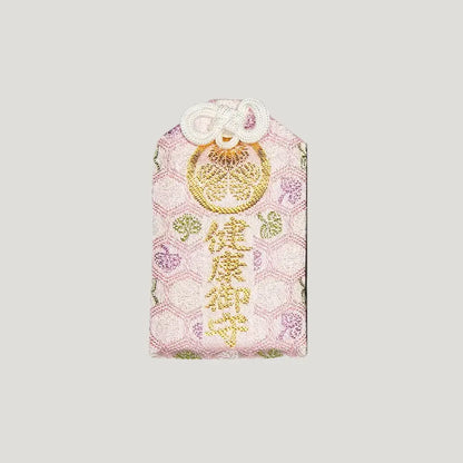 Front of 健康御守 (Health Protection Omamori) in pink from Zojoji Temple – gold embroidery with floral hexagon pattern