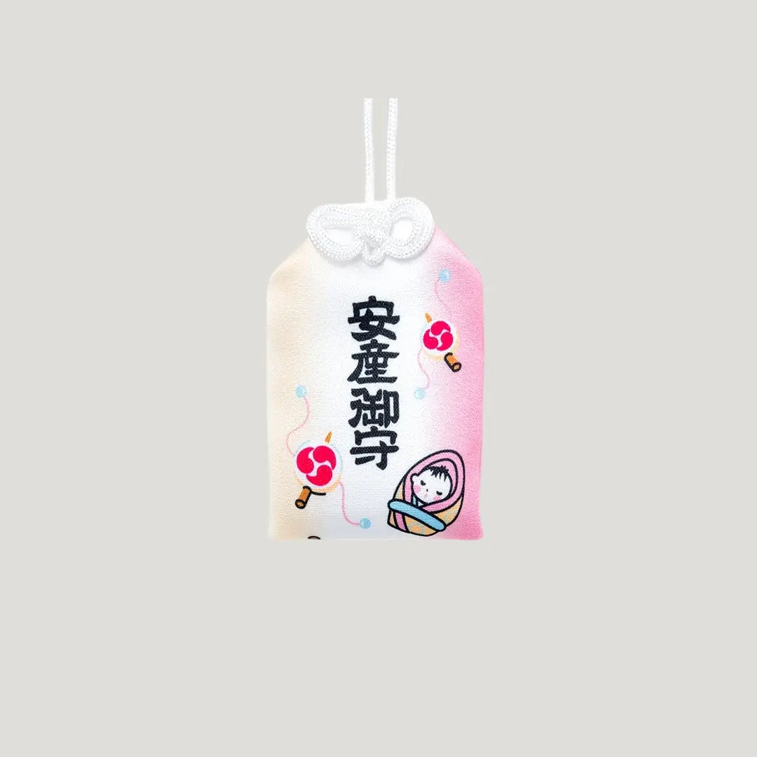 Healthy Delivery Omamori (安産成就お守り) front view – pink and white Japanese charm with baby and drum motif, blessed for safe childbirth at Shirasaki Shrine