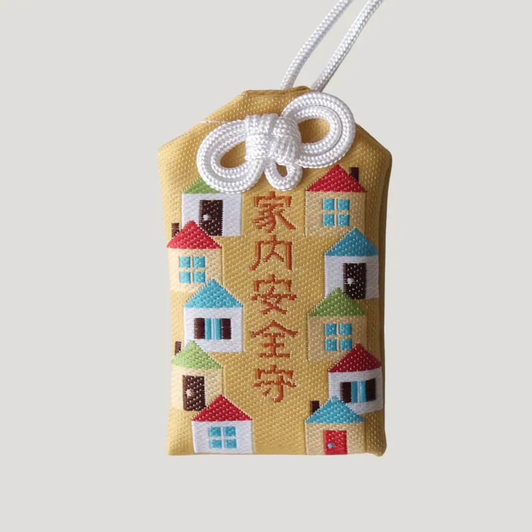 Household Safety Omamori from Koenji Hikawa Shrine with colorful house design on gold background symbolizing peace and protection for the home
