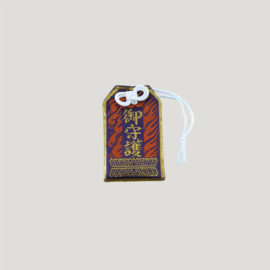 Misfortune Protection Omamori from Osaka Naritasan Fudoson with bold woven pattern and traditional pouch for warding danger