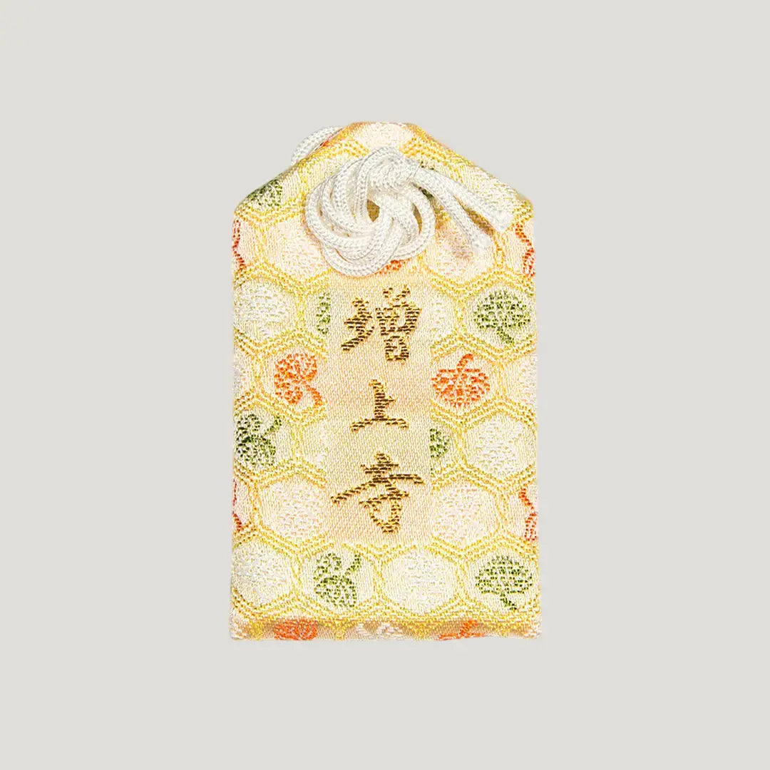 Back of 厄除御守 (Protection from Misfortune Omamori) from Zojoji Temple – brocade fabric with 増上寺 embroidered in gold