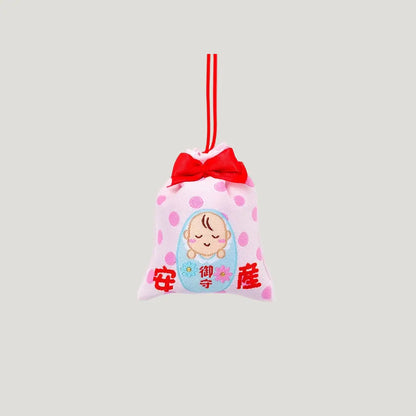 Safe Childbirth Omamori (安産お守り) front view – pink Japanese charm with baby motif, red ribbon, and polka dots from Shirasaki Shrine for pregnancy protection