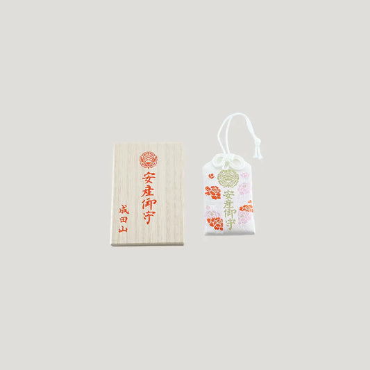 Safe Childbirth Omamori from Osaka Naritasan Fudoson in white with floral accents and gold embroidery, includes wooden case