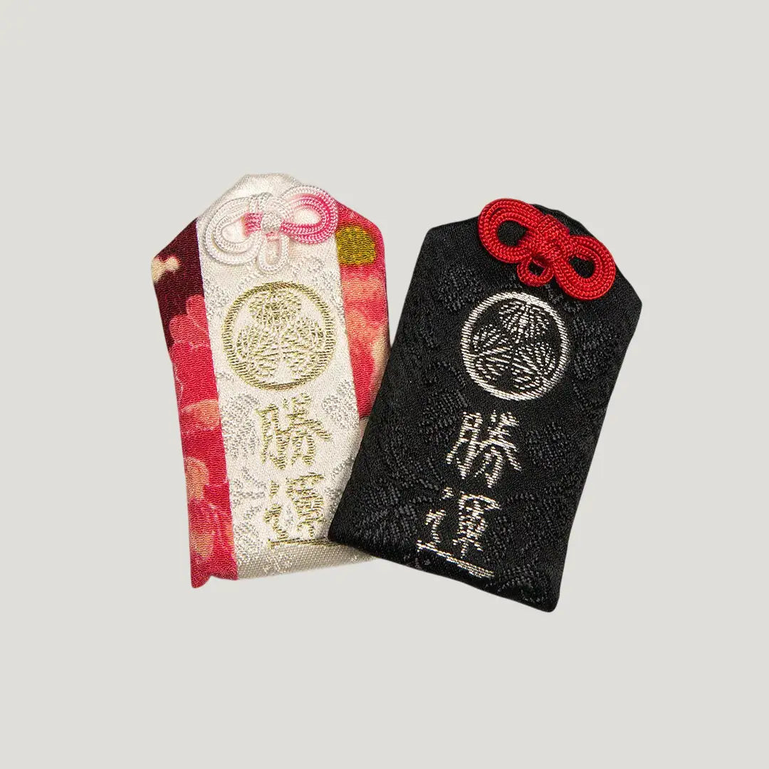 Victory & Fortune Omamori from Zojoji Temple – two variants shown: Black (黒) and Patterned – 雅色. Sold individually; select your preferred type.