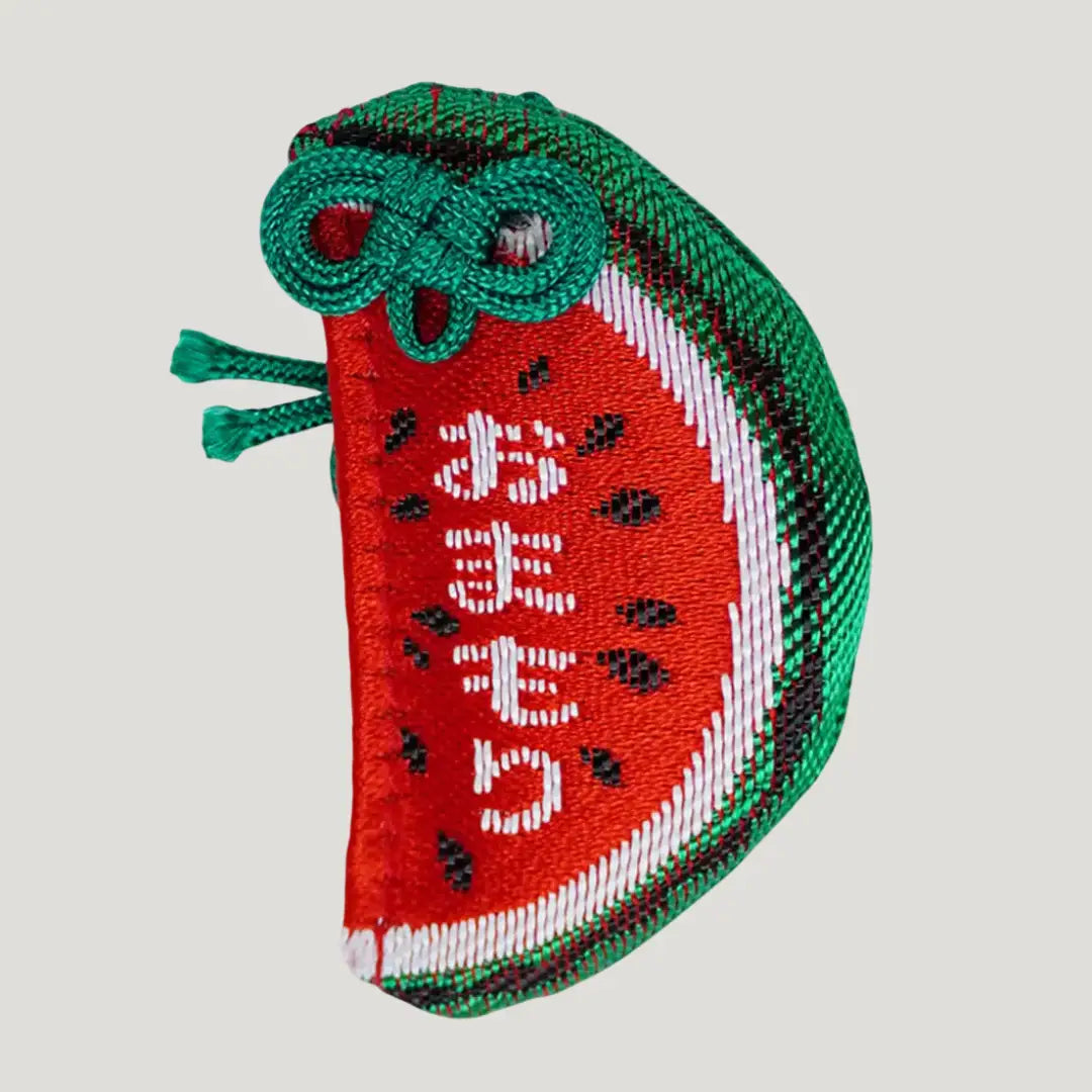 Japanese watermelon omamori charm from Hasedera Kamakura in packaging, brings good luck, health, and success in life