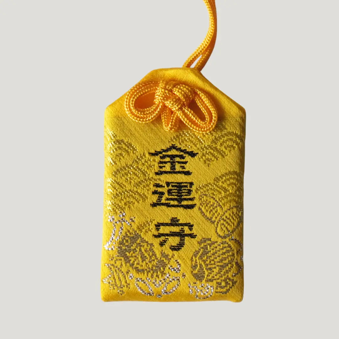 Wealth Omamori from Koenji Hikawa Shrine in yellow with gold embroidery and treasure motifs, symbolizing luck, prosperity, and financial blessings