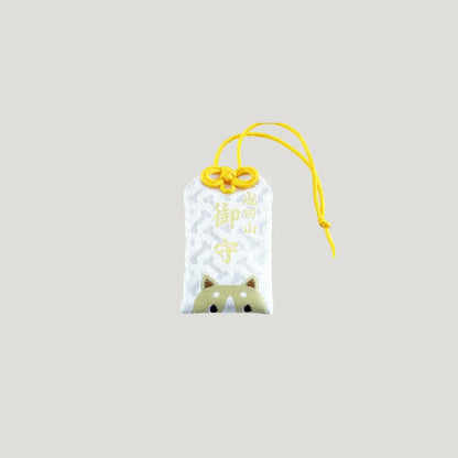Dog Zodiac Omamori from Osaka Naritasan Fudoson featuring a shiba-like face with yellow cord